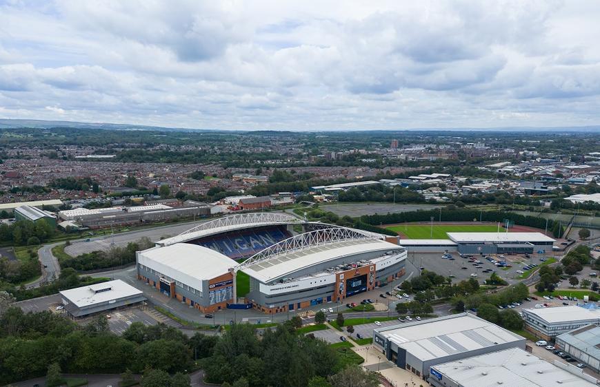 Air conditioning installation Wigan | aerial view of the DW Stadium, home to Wigan Athletic football and Wigan Warriors rugby, Wigan, Manchester, England.